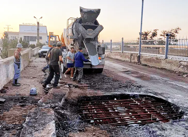 Рабочие заделывают пробоину, оставшуюся после американского Хаймарса
